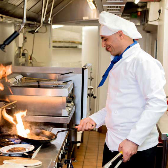 Riverwalk Estates chef cooking meal in kitchen