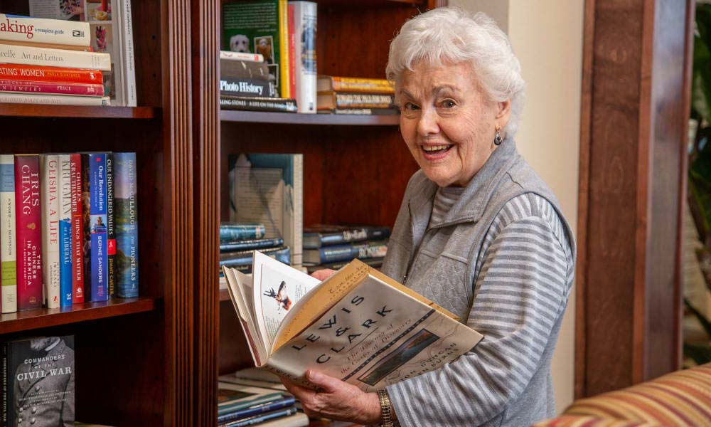 Independent senior near Burbank selecting a book